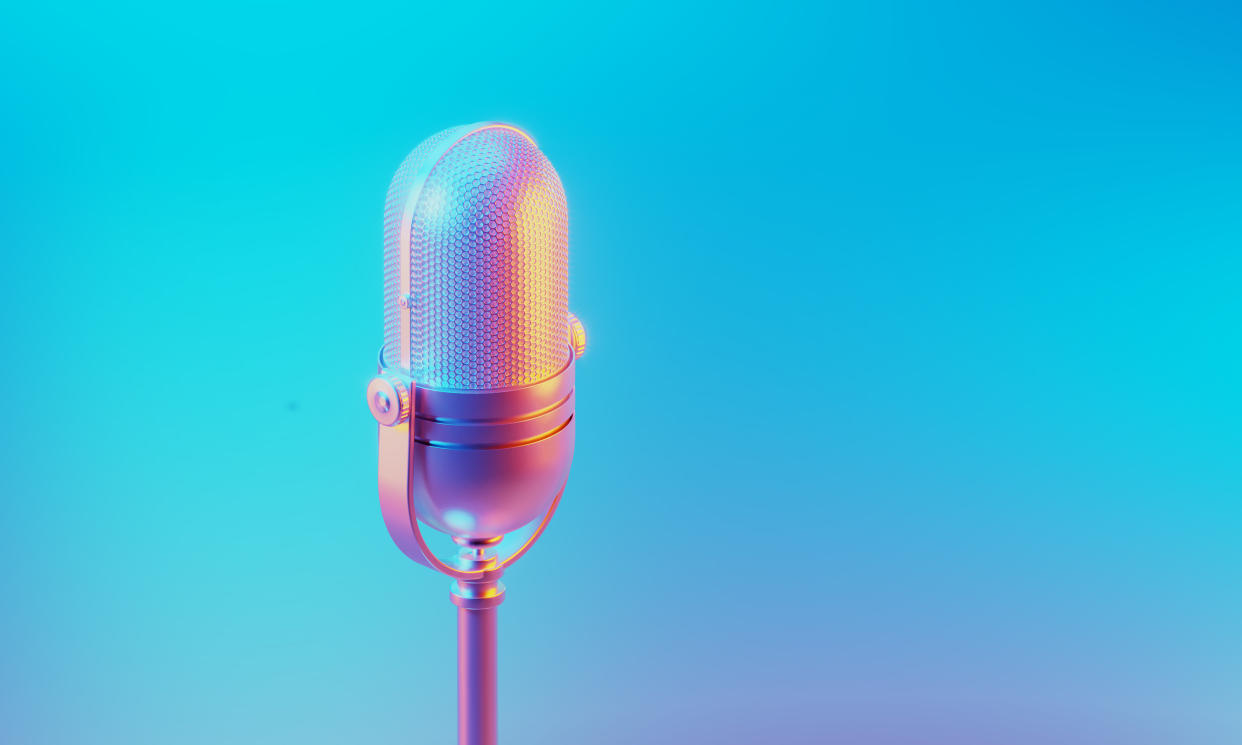  Microphone illuminated by blue and pink lights on blue and pink background. 