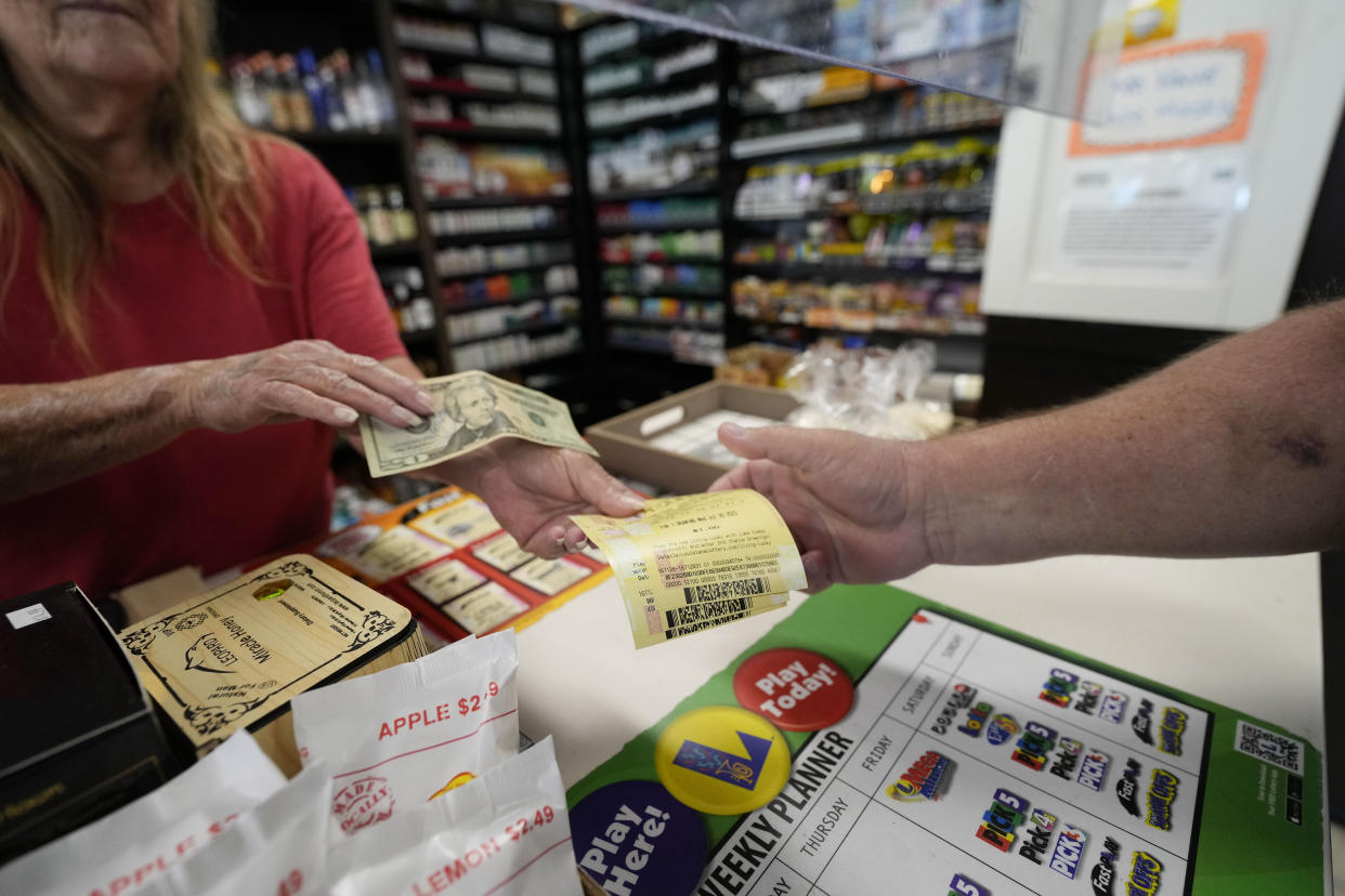 Cashier Rosemary Probst sells tickets for the Mega Millions lottery at the Save 'N Time convenience store in Harahan, La., Wednesday, July 26, 2023. The Mega Millions lottery jackpot is approaching $1 billion ahead of Friday’s drawing. (AP Photo/Gerald Herbert)