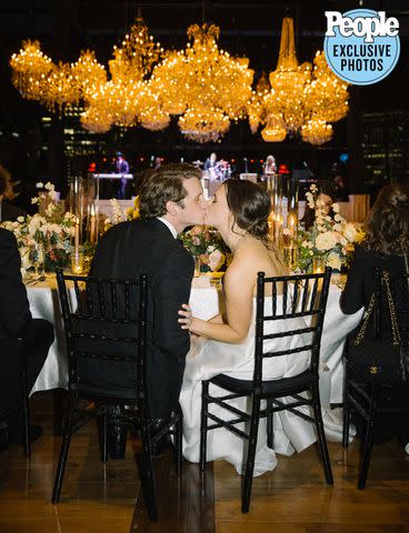 <p>Leah Margulies Photography</p> Ford Garrard and Taylor Davis share a kiss during their wedding reception