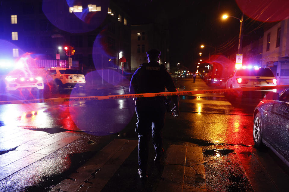 Police investigate the scene of a shooting Monday, July 3, 2023 in Philadelphia. Police say a gunman in a bulletproof vest has opened fire on the streets of Philadelphia, killing several people and wounding two boys before he surrendered to responding officers. (Steven M. Falk/The Philadelphia Inquirer via AP)