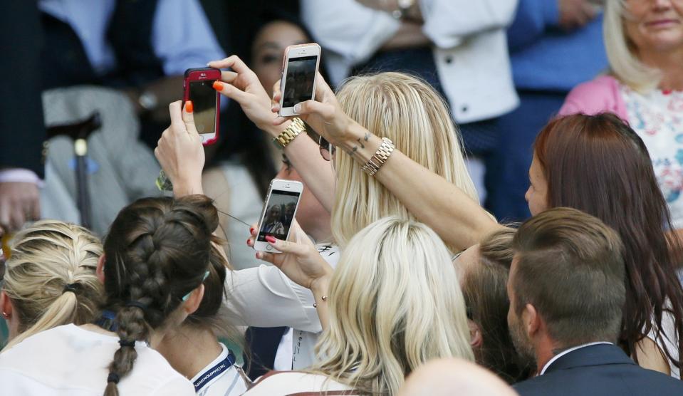 Former footballer David Beckham (R) poses for selfies with the England Women's football team on Centre Court at the Wimbledon Tennis Championships in London, July 9, 2015. REUTERS/Stefan Wermuth