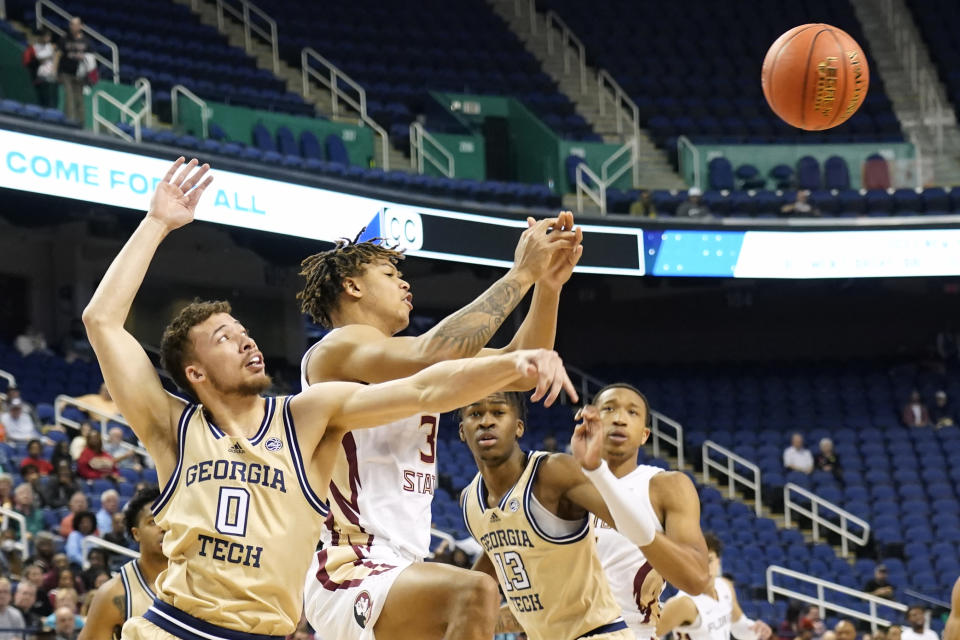 Florida State forward Cam Corhen (3) and Georgia Tech guard Lance Terry (0) battle for a rebound during the first half of an NCAA college basketball game at the Atlantic Coast Conference Tournament in Greensboro, N.C., Tuesday, March 7, 2023. (AP Photo/Chuck Burton)