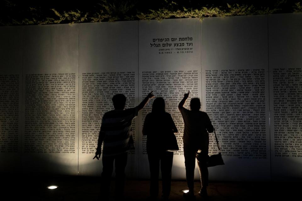 People look for names of fallen soldiers before a ceremony commemorating the 50th anniversary of the 1973 Yom Kippur war at the Armored Corps memorial site in Latrun, Israel, Wednesday, Sept. 27, 2023.