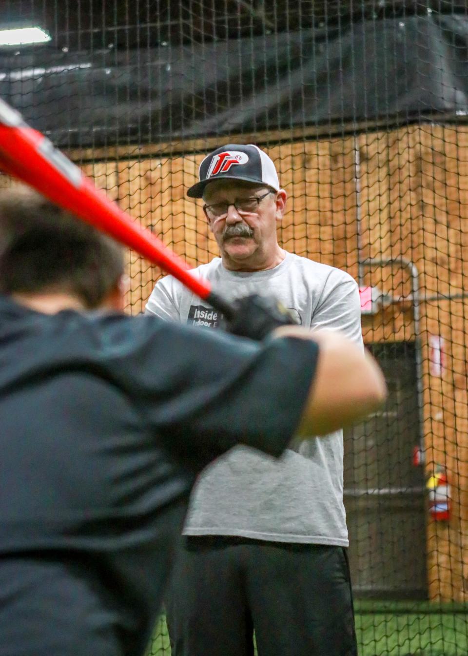 Jeff Antil studies the swing of Colton Linhares during his hitting session on Monday evening at Inside The Park Batting Cages.
