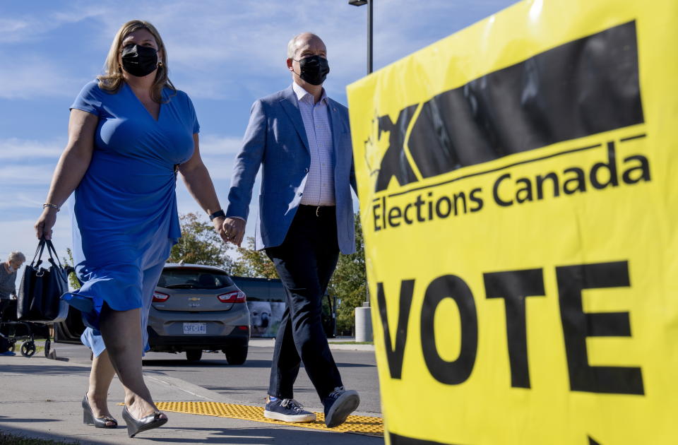 Conservative Leader Erin O'Toole and his wife Rebecca arrive to vote in the Canadian federal election in Bowmanville, Ontario on Monday, September 20, 2021. (Frank Gunn/The Canadian Press via AP)