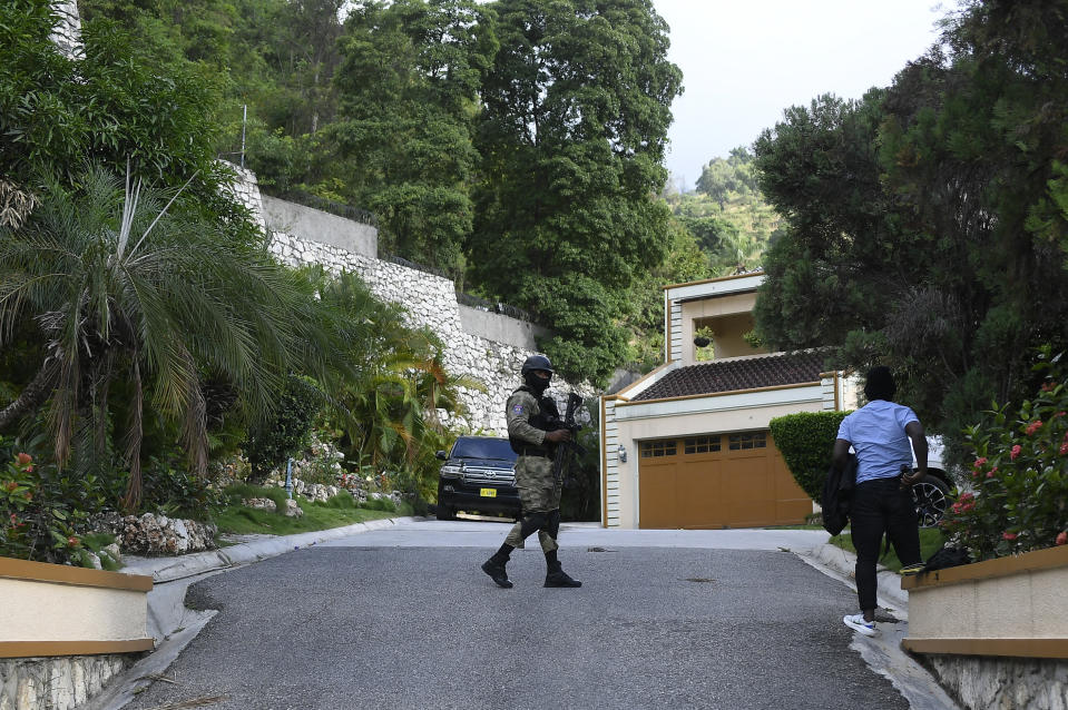 A Haitian police officer guards the residence President Jovenel Moise in Port-au-Prince, Haiti, Thursday, July 15, 2021, as FBI agents assisting the investigation of his assassination inspect the house. (AP Photo/Matias Delacroix)