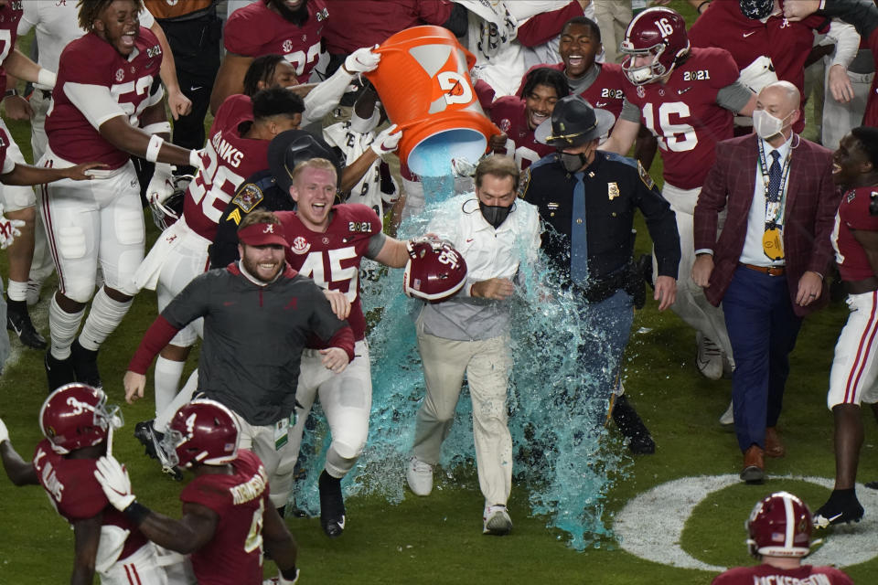 Alabama head coach Nick Saban is soaked in a sports drink after their win against Ohio State in an NCAA College Football Playoff national championship game, Monday, Jan. 11, 2021, in Miami Gardens, Fla. Alabama won 52-24. (AP Photo/Wilfredo Lee)