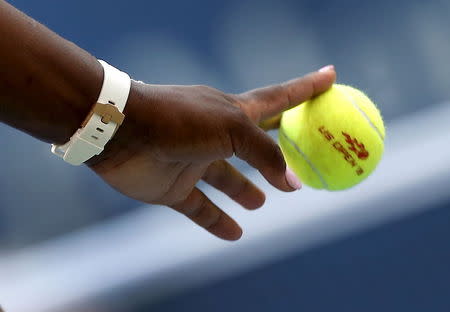 Serena Williams of the U.S. bounces a tennis ball as she prepares to serve to Kiki Bertens of the Netherlands at the U.S. Open Championships tennis tournament in New York, September 2, 2015. REUTERS/Mike Segar