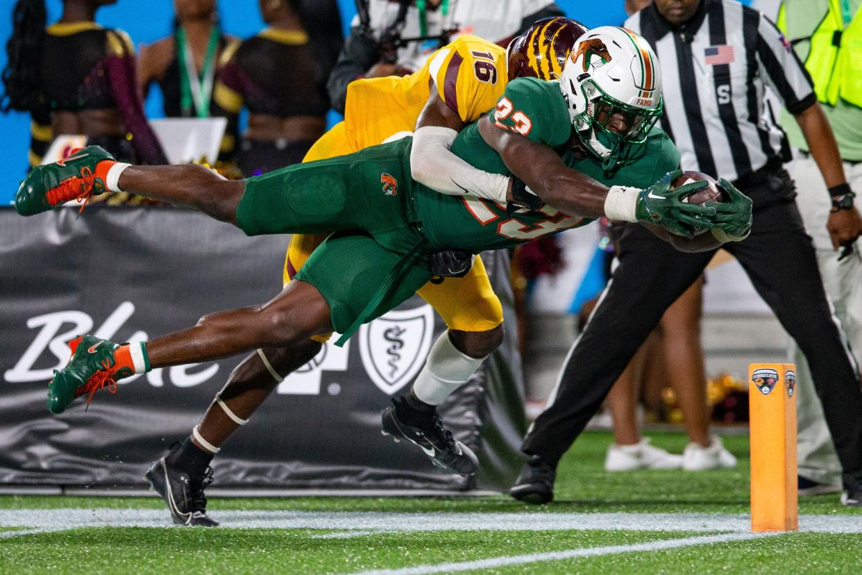 Florida A&M Rattlers running back Terrell Jennings (23) stretches forward to cross the goal line for a touchdown. The Florida A&M Rattlers defeated the Bethune Cookman Wildcats 24-7 in the Florida Classic at Camping World Stadium on Saturday, Nov. 18, 2023.