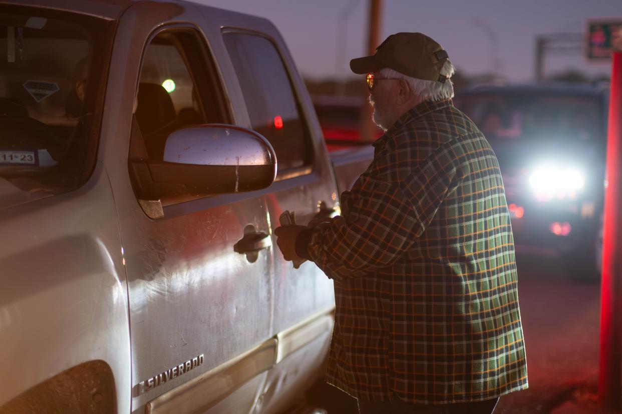 Familes gather by the carload Friday night at the Tascosa Drive-in's final show in Amarillo.