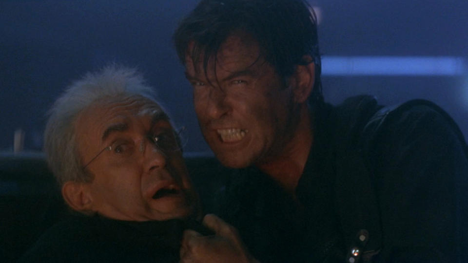 Pierce Brosnan angrily holds Jonathan Pryce by the shirt in Tomorrow Never Dies.