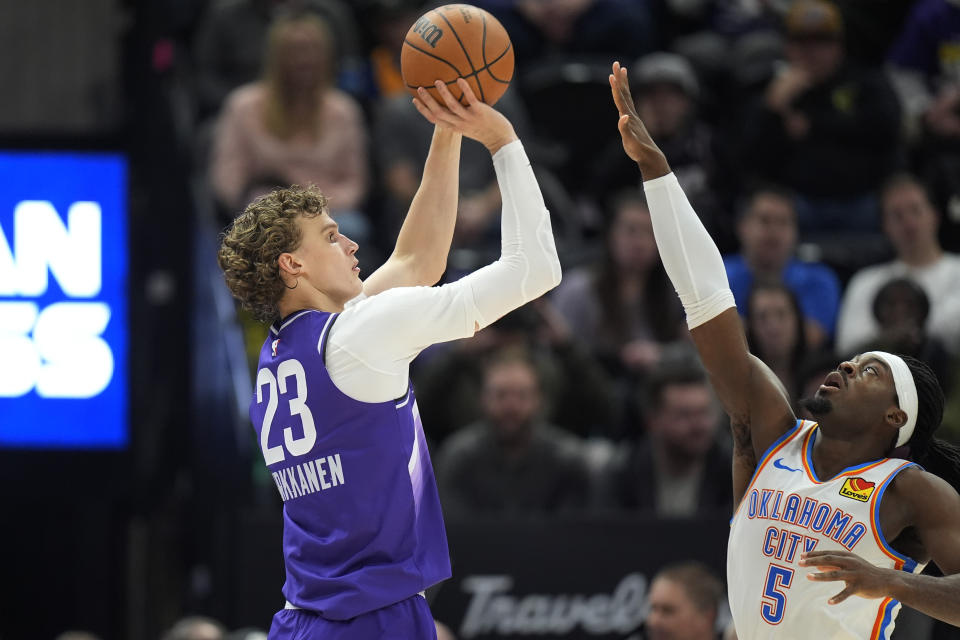 Utah Jazz forward Lauri Markkanen (23) shoots as Oklahoma City Thunder guard Luguentz Dort (5) defends during the first half of an NBA basketball game Tuesday, Feb. 6, 2024, in Salt Lake City. (AP Photo/Rick Bowmer)