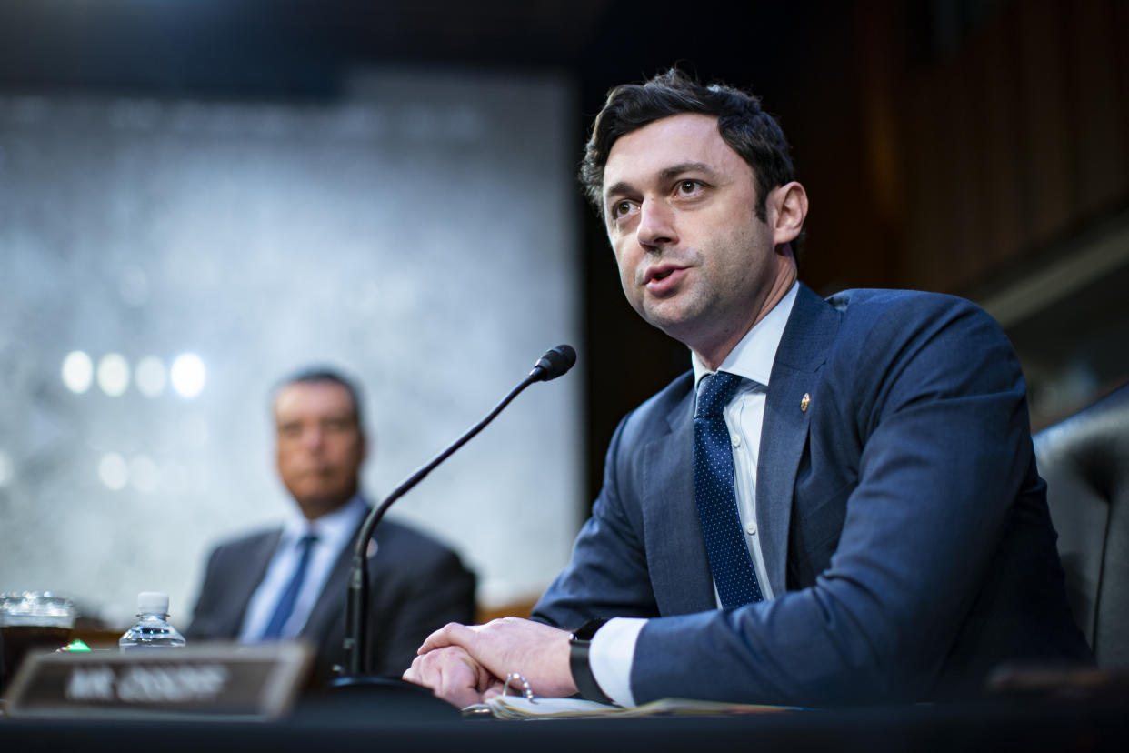 Sen. Jon Ossoff, D-Ga., speaks into a microphone at a hearing.