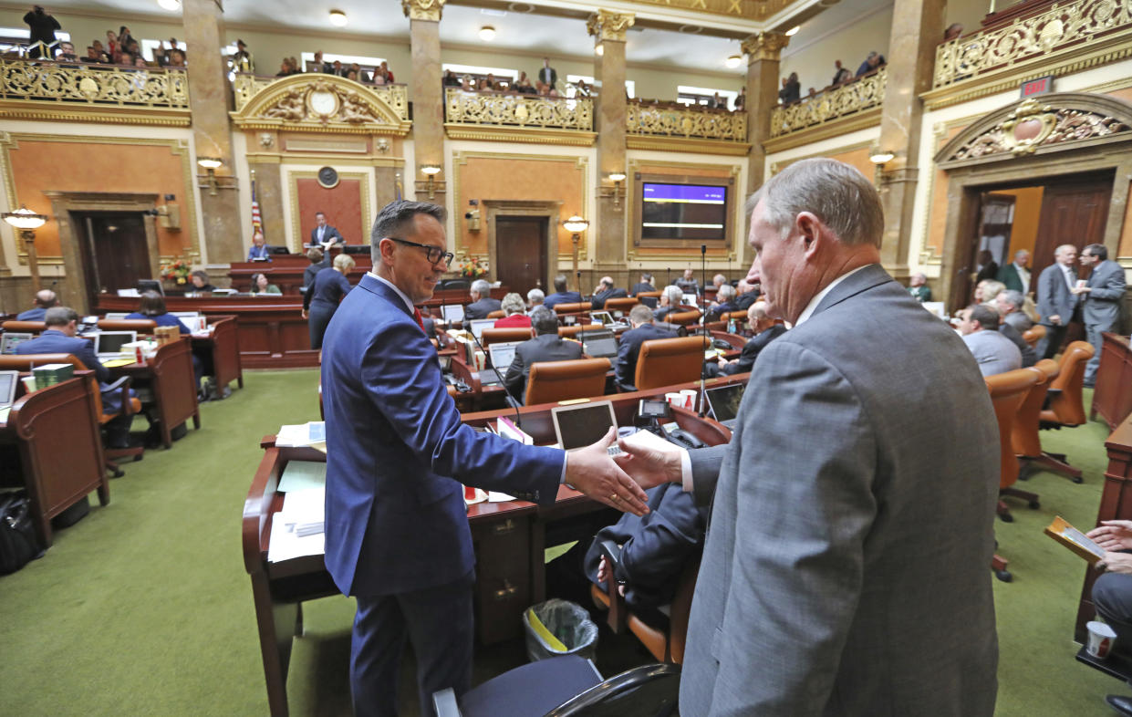 Outgoing Republican House Speaker Greg Hughes, left, receives a handshake from Republican Sen. Evan Vickers after the Utah House of Representatives passed a compromise plan to legalize medical marijuana during a special session, Dec. 3, 2018. (Photo: Rick Bowmer/AP)