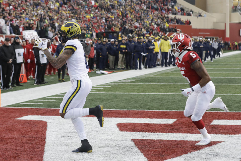 Michigan wide receiver Ronnie Bell (8) makes a touchdown reception against Indiana defensive back Juwan Burgess (5) during the first half of an NCAA college football game, Saturday, Nov. 23, 2019, in Bloomington, Ind. (AP Photo/Darron Cummings)