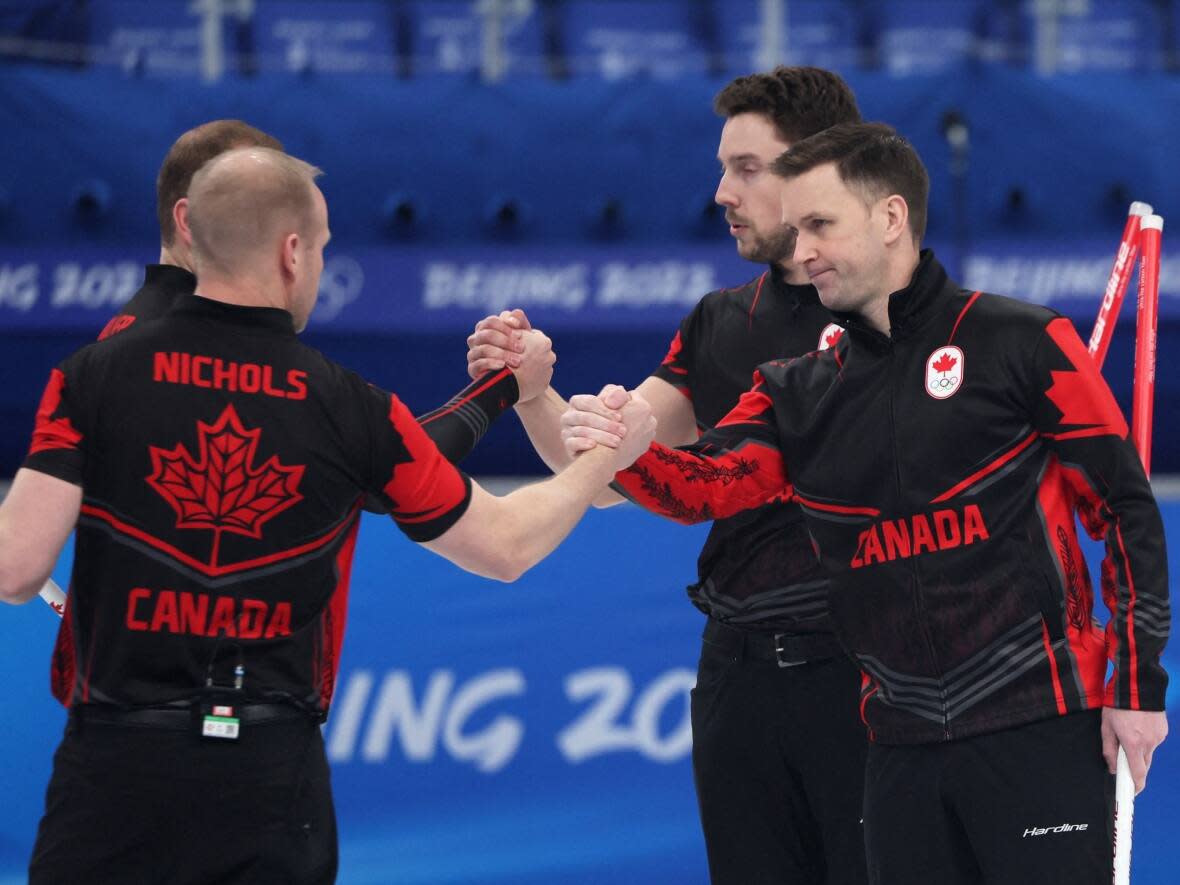 Brad Gushue, right, celebrates with his teammates after their 10-8 win over China at the Beijing Olympics. Team Gushue will look slightly different for the 2022-23 season after Brett Gallant left the team in May. (Evelyn Hockstein/Reuters - image credit)