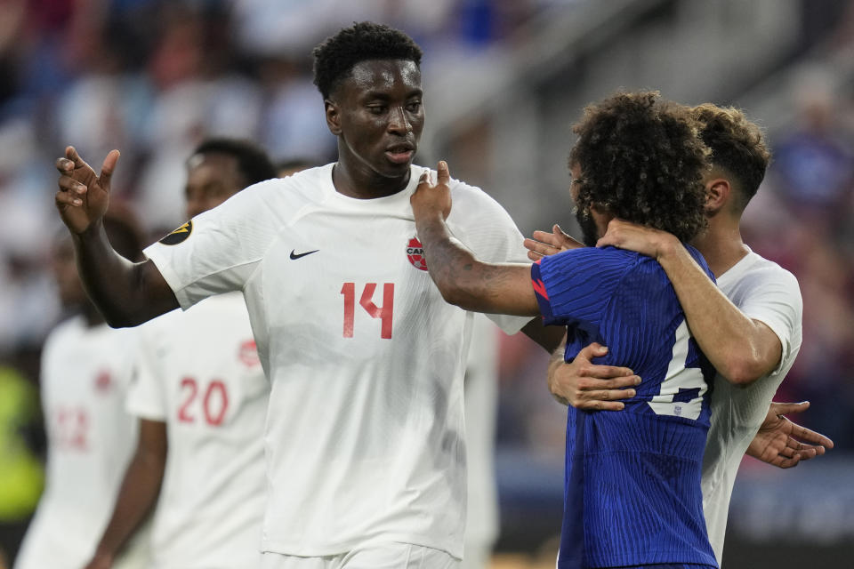 Canada defender Moïse Bombito (14) and Canada midfielder Jonathan Osorio (21) speak with United States midfielder Gianluca Busio (6) during a CONCACAF Gold Cup semi-final soccer match, Sunday, July 9, 2023, in Cincinnati. (AP Photo/Michael Conroy)