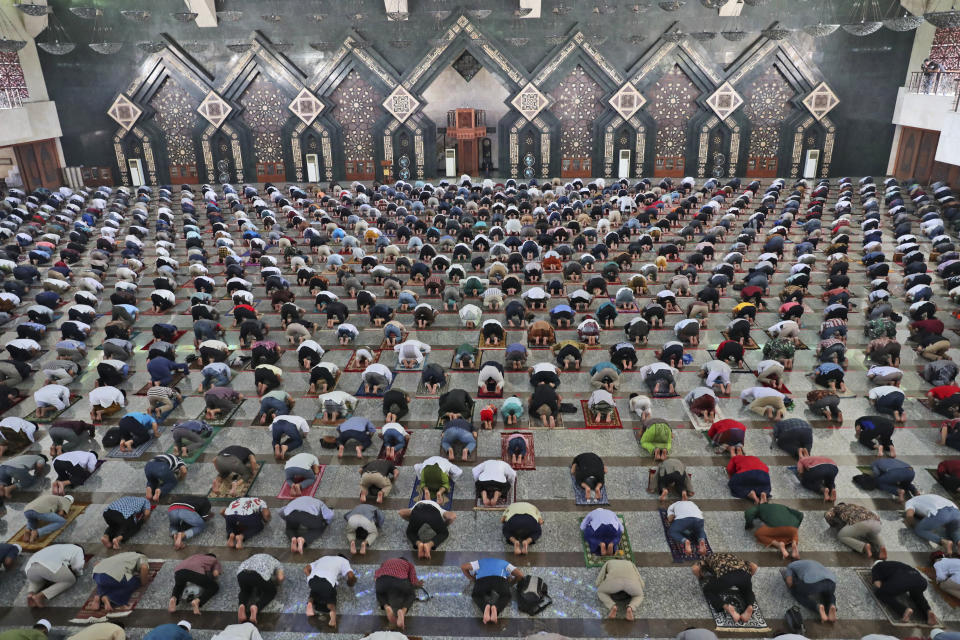 Muslim men pray spaced apart amid concerns of coronavirus outbreak during a Friday prayer at At-Tin mosque in Jakarta, Indonesia, Friday, June 5, 2020. Muslims in Indonesia's capital held their first communal Friday prayers as mosques closed by the coronavirus outbreak for nine weeks reopened at half capacity. (AP Photo/Achmad Ibrahim)