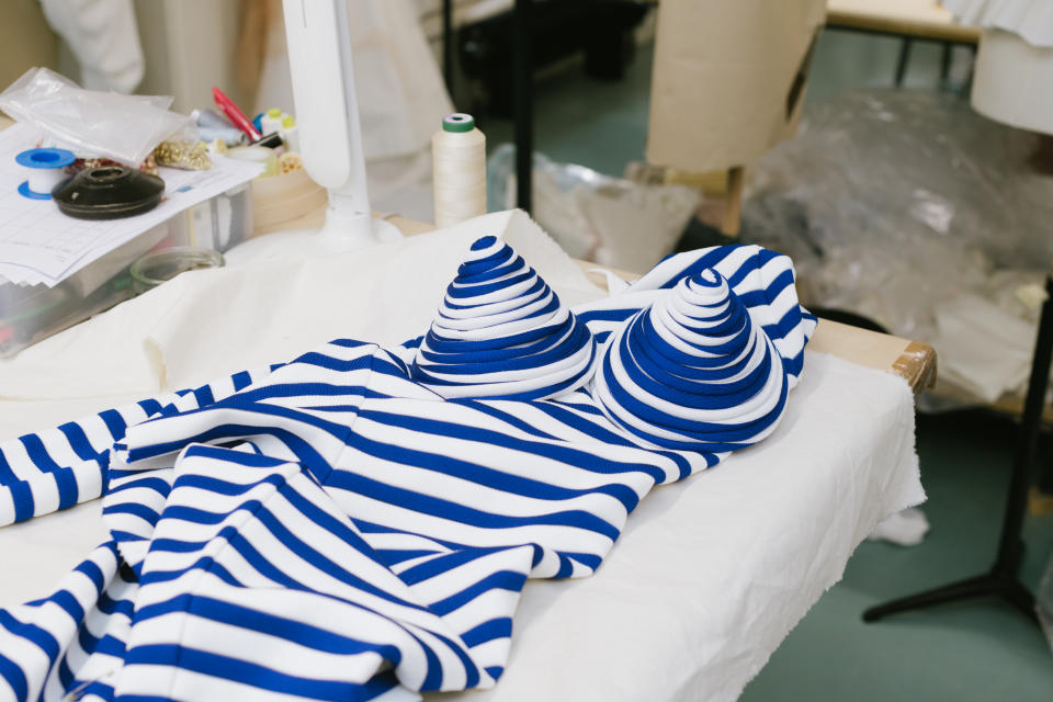 A garment under construction blending sailor stripes and a cone bra – very Jean Paul Gaultier. - Credit: Vanni Bassetti