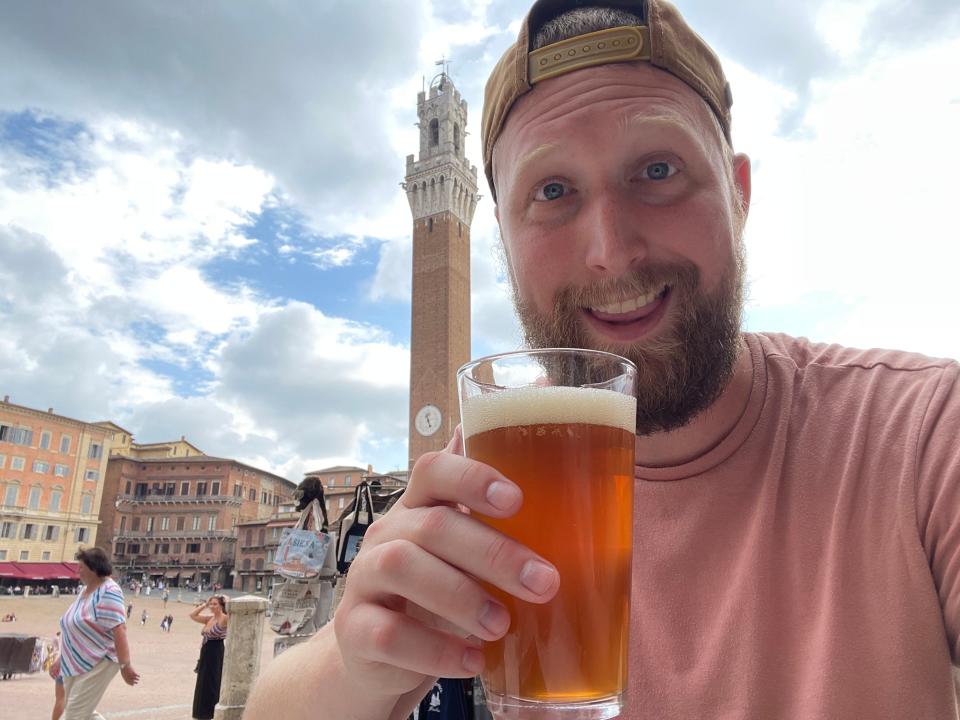 Author Timothy Moore drinking a beer in Siena