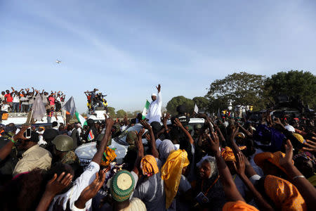 Gambia's President Adama Barrow, who was sworn in at the Gambian embassy in neighbouring Senegal, greets his supporters upon his arrival from Dakar, in Banjul, Gambia January 26, 2017. REUTERS/Afolabi Sotunde