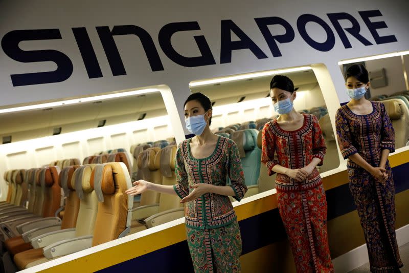 FILE PHOTO: Cabin crew speak to participants during a guided tour at the Singapore Airlines Training Centre in Singapore