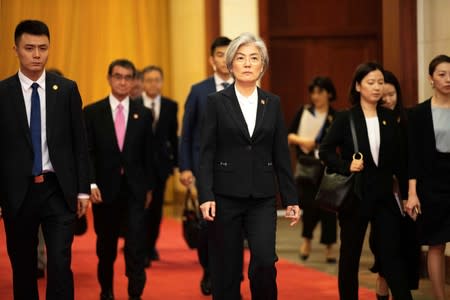 South Korean Foreign Minister Kang Kyung-wha and Japanese Foreign Minister Taro Kono arrive for their meeting with Chinese Premier Li Keqiang at the Great Hall of the People (GHOP) in Beijing
