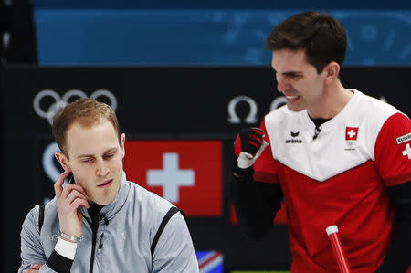 Curling - Pyeongchang 2018 Winter Olympics - Men’s Tie-Breaker - Switzerland v Britain - Gangneung Curling Center - Gangneung, South Korea - February 22, 2018 - Kyle Smith of Britain and Peter de Cruz of Switzerland react. REUTERS/Cathal McNaughton