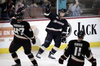 Anaheim Ducks' Andrew Cogliano, center, celebrates his goal with Hampus Lindholm, left, of Sweden, during the first period of an NHL hockey game against the Vancouver Canucks on Wednesday, Jan. 15, 2014, in Anaheim, Calif. (AP Photo/Jae C. Hong)