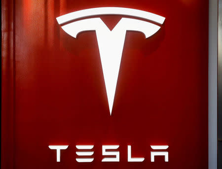 FILE PHOTO: The Tesla logo is seen at the entrance to Tesla Motors' new showroom in Manhattan's Meatpacking District in New York City, U.S., December 14, 2017. REUTERS/Brendan McDermid/File Photo