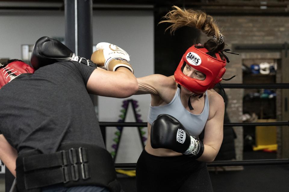 Claire Quinn, 30, spars with coach Miguel Martinez as she trains for her 156-pound Chicago Golden Gloves boxing match at Unanimous Boxing Gym Friday, March 17, 2023, in Chicago. “One thing that I really like about boxing in general is that I’m one of those people that constantly wants to learn something, and there’s always something to learn in the sport,” says Quinn. (AP Photo Erin Hooley)