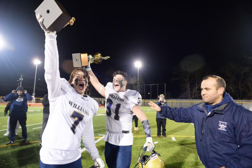 From left, Archbishop Williams Matt Kowalski, Shawn Harrington, and head coach Matthew Reggiannin at the conclusion of a game versus Cardinal Spellman on Wednesday, Nov. 24, 2021.