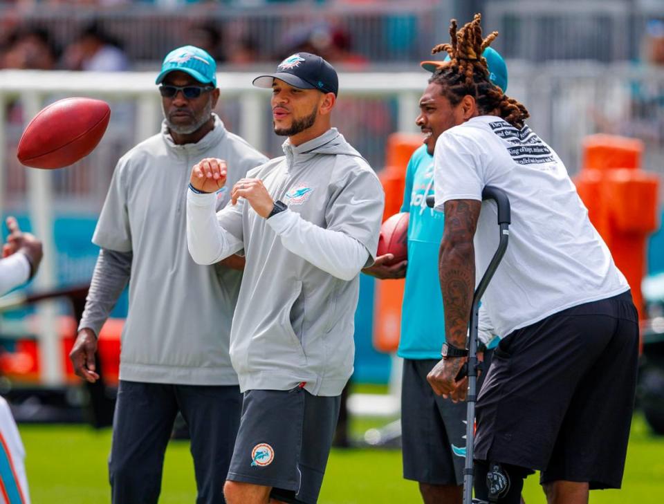 Miami Dolphins cornerback Jalen Ramsey (5) talks with team coaches Sam Madison, Renaldo Hill and Mathieu Araujo and walks on the field during NFL football training camp at Baptist Health Training Complex in Hard Rock Stadium on Thursday, August 3, 2023 in Miami Gardens, Florida.