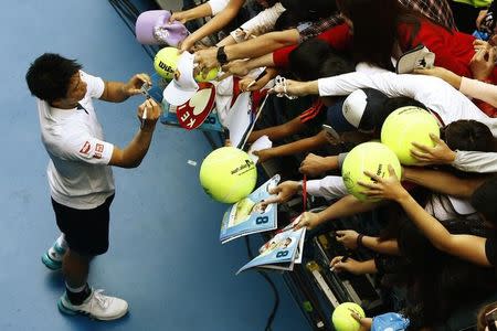 Japan's Kei Nishikori signs autographs after winning his fourth round match against France's Jo-Wilfried Tsonga at the Australian Open tennis tournament at Melbourne Park, Australia, January 24, 2016. REUTERS/Jason Reed