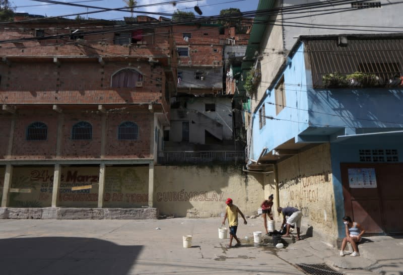 People extract water from an unknown source in the low-income neighbourhood of Petare amid the coronavirus disease (COVID-19) outbreak in Caracas