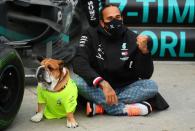 <p>Lewis Hamilton celebrates winning the F1 World Drivers Championship with his dog Roscoe at Intercity Istanbul Park on Sunday in Istanbul, Turkey.</p>