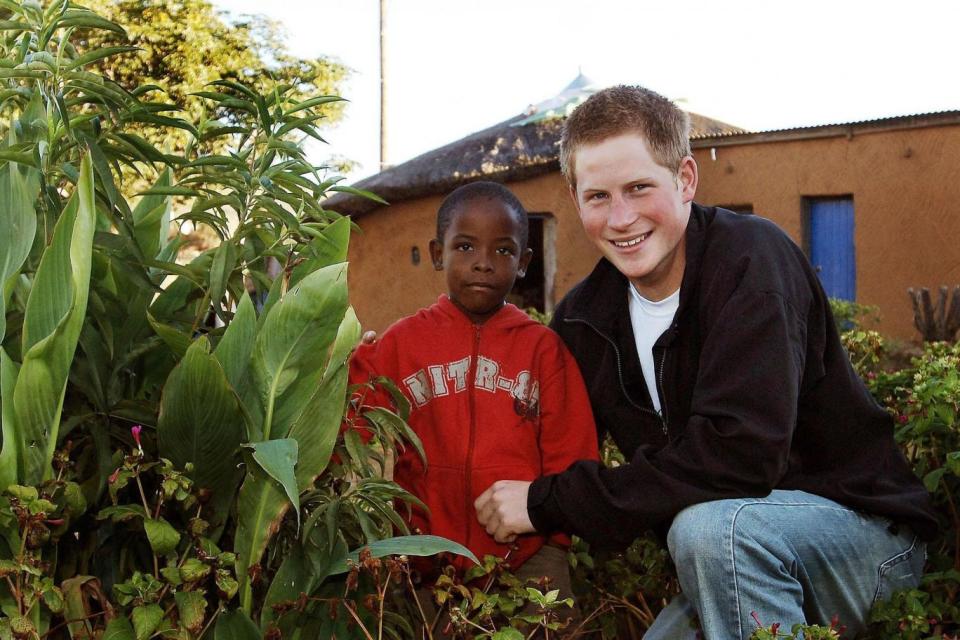 Harry and Mutsu with a tree they planted in the grounds of the Mants'ase childrens home in March 2004 (PA Archive/PA Images)