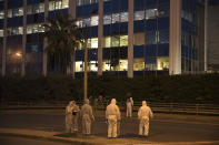 Greek forensic experts search at the scene after a powerful bomb exploded outside private Greek television station, in Faliro, Athens, Monday, Dec, 17, 2018. Police said the blast occurred outside the broadcasters' headquarters near Athens after telephoned warnings prompted authorities to evacuate the building, causing extensive damage but no injuries. (AP Photo/Petros Giannakouris)