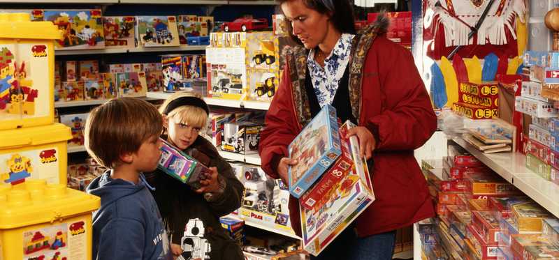 Children and female parent in a toystore.