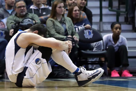 Andrew Bogut #6 of the Dallas Mavericks sits on the court after a injury during play against the Charlotte Hornets  on December 5, 2016 in Dallas, Texas.