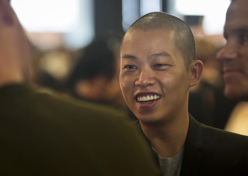 Fashion designer Jason Wu reacts as he chats backstage before showing his Spring Summer 2014 collection on Friday, Sept. 6, 2013 in New York. (AP Photo/Bebeto Matthews)