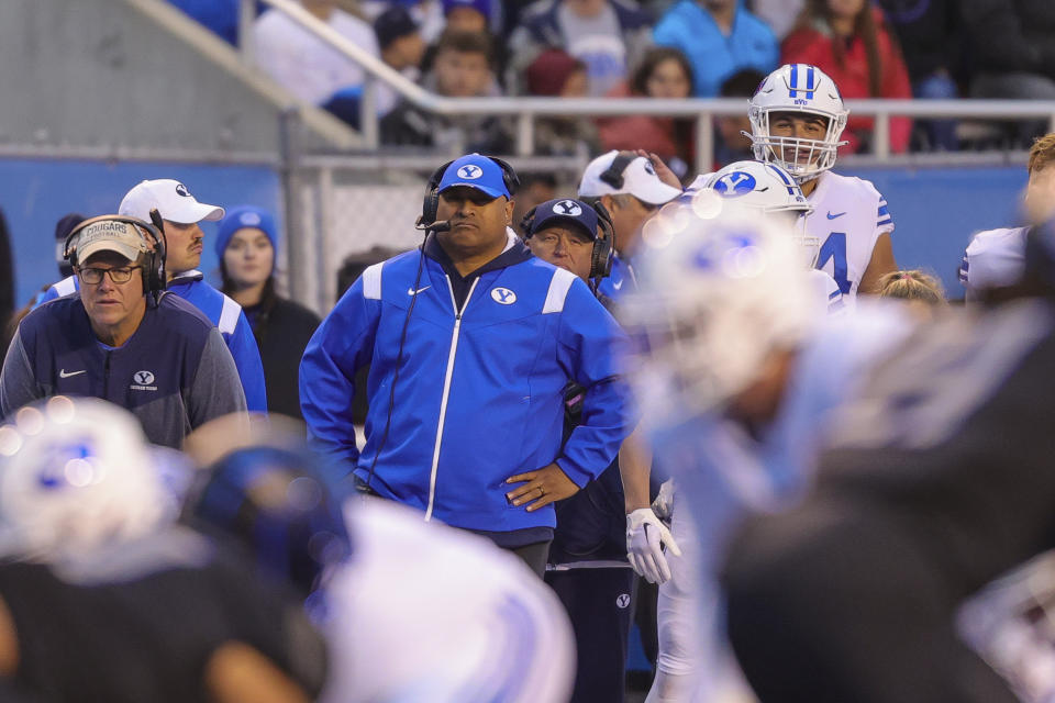 BYU head coach Kalani Sitake, center, looks on from the sideline before the snap against Boise State in the first half of an NCAA college football game, Saturday, Nov. 5, 2022, in Boise, Idaho. (AP Photo/Steve Conner)