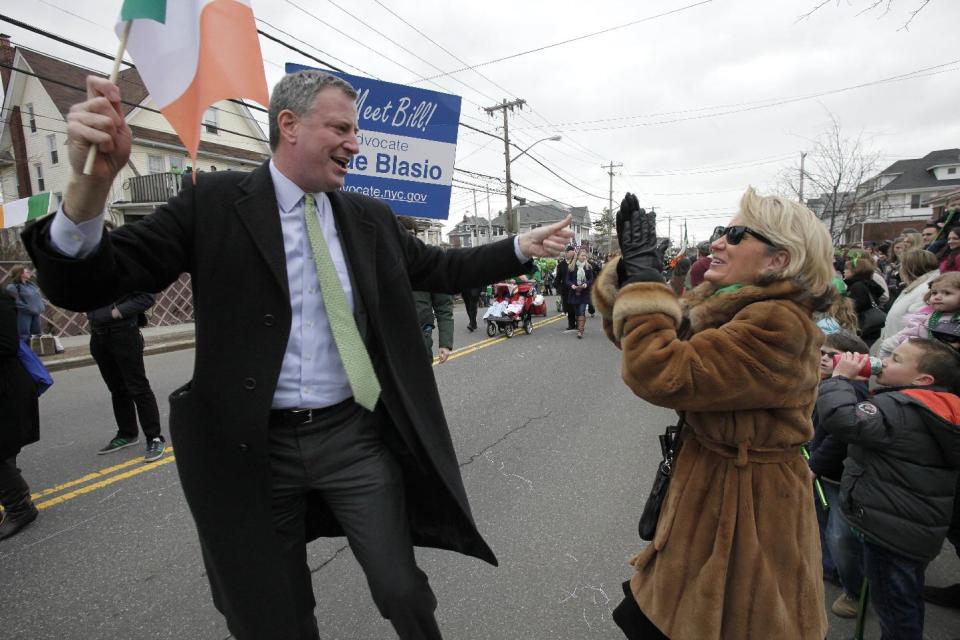 FILE - In this Saturday, March 2, 2013 file photo, New York City Public Advocate Bill de Blasio marches in the Queens County St. Patrick's Day Parade in the Rockaway area of the Queens borough of New York. As mayor in 2014, de Blasio said he will skip the nation’s largest St. Patrick’s Day parade in Manhattan because participants are not allowed to carry signs or banners that identify themselves as gay. Since the 1990s, the Manhattan parade's ban on gay signs and banners has spurred protests and litigation and led to the creation of this alternative, gay-friendly St. Patrick's Day parade in Queens. (AP Photo/Mark Lennihan)