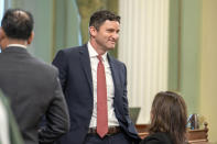 Assemblyman Jesse Gabriel, chair of the Assembly Budget committee, smiles as a measure to reduce the state deficit is approved the Assembly at the Capitol in Sacramento, Calif., Thursday, April 11, 2024. Both houses approved the bill that takes a number of steps to reduce the state budget deficit by about $17 billion. Gov. Gavin Newsom has said the deficit is about $38 billion. (AP Photo/Rich Pedroncelli)