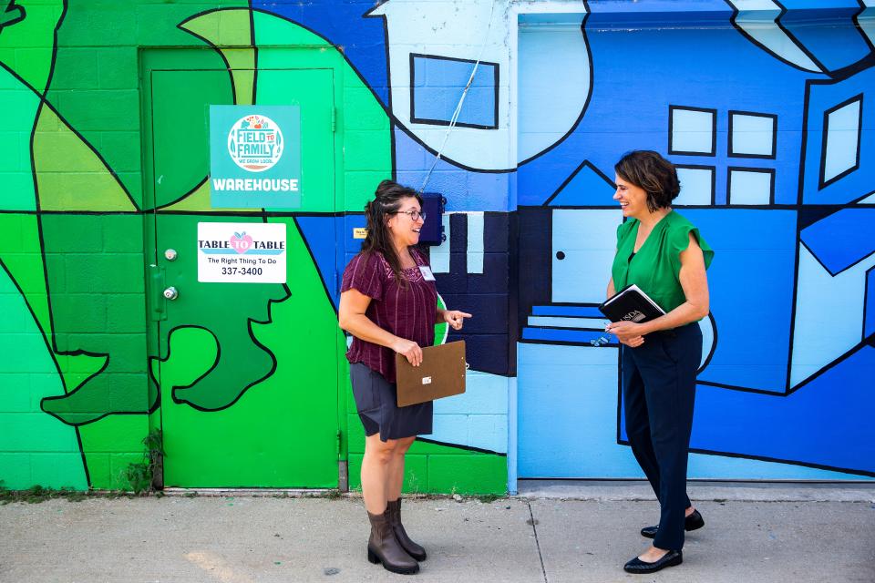 Michelle Kenyon, director of Field to Family, left, talks with Theresa Greenfield, USDA Rural Development State Director in Iowa, during a tour of Field to Family on Sept. 15 in Iowa City.