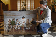 Baseball artist Graig Kreindler holds his unfinished painting of Babe Ruth and children, Wednesday, April 29, 2020, in the lobby of his residence in the Brooklyn borough of New York. The painting is based on a photograph from the fall of 1924. Kreindler says Ruth wears a uniform that was never actually used by the Yankees, "one that perhaps was used for a barnstorming tour." Some 230 of Kreindler's paintings are currently part of an exhibit at the Negro Leagues Baseball Museum in Kansas City, but the museum was forced to shut down in mid-March due to coronavirus concerns. As of now, it's scheduled to reopen early in June. (AP Photo/Kathy Willens)