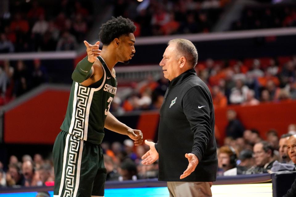 Michigan State's Jaden Akins, left, talks with coach Tom Izzo during a break in play in the first half of the team's NCAA college basketball game against Illinois on Thursday, Jan. 11, 2024, in Champaign, Ill. (AP Photo/Charles Rex Arbogast)
