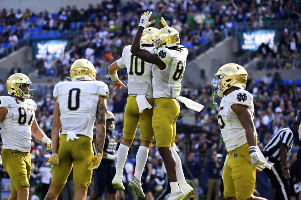 Notre Dame wide receiver Jayden Thomas, right, celebrates his first half touchdown with quarterback Drew Pyne (10) during an NCAA college football game, Saturday, Nov. 12, 2022, in Baltimore. (AP Photo/Terrance Williams)