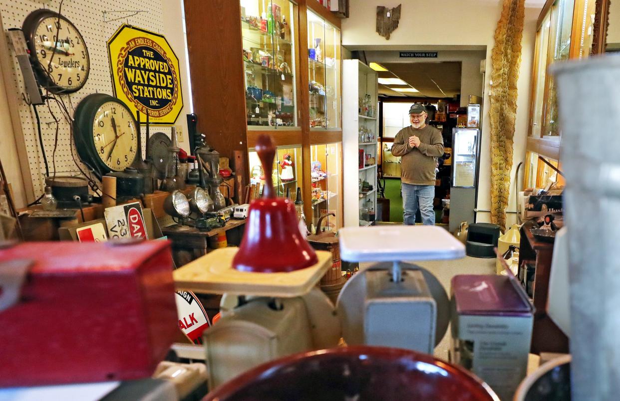 John Mack of Copley Circle Antiques takes a stroll through his shop in Copley recently.