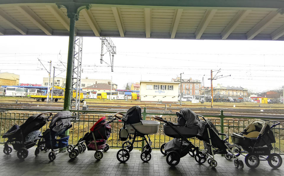 FILE - Strollers for refugees and their babies fleeing the conflict from neighbouring Ukraine are left at the train station in Przemysl, Poland, Wednesday, March 2, 2022. Since the invasion of Ukraine more than eight months ago, Poland has aided the neighboring country and millions of its refugees — both to ease their suffering and to help guard against the war spilling into the rest of Europe. But a missile strike that killed two men Tuesday, Nov. 15 in a Polish village close to the Ukrainian border brought the conflict home and added to the long-suppressed sense of vulnerability in a country where the ravages of World War II are well remembered. (AP Photo/Francesco Malavolta, File)